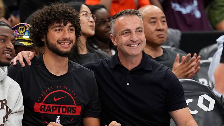 Jun 27, 2026; Toronto, Ontario, CAN;  Toronto Raptors 2026 first round draft pick Allen Graves (left) poses courtside with head coach Darko Rajakovic (right) during a game between the Phoenix Mercury and Toronto Tempo at Scotiabank Arena. Mandatory Credit: John E. Sokolowski-Imagn Images