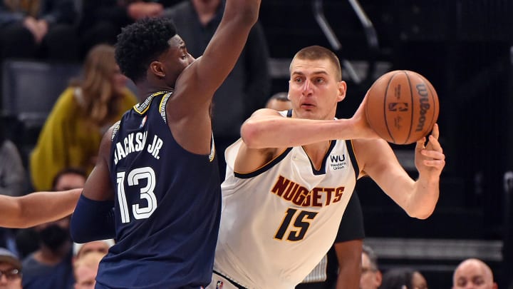 Denver Nuggets center Nikola Jokic (15) passes against Memphis Grizzlies forward Jaren Jackson Jr. (13) during the second half at FedExForum. Mandatory Credit: