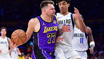 Los Angeles Lakers guard Luka Doncic (77) dribbles the ball by Dallas Mavericks guard Max Christie (00) during the second half at Crypto.com Arena.