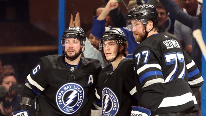 Feb 15, 2024; Tampa, Florida, USA; Tampa Bay Lightning center Brayden Point (21) is congratulated by defenseman Victor Hedman (77) and right wing Nikita Kucherov (86) after he scored a final against the Colorado Avalanche uring the first period at Amalie Arena. Mandatory Credit: Kim Klement Neitzel-USA TODAY Sports