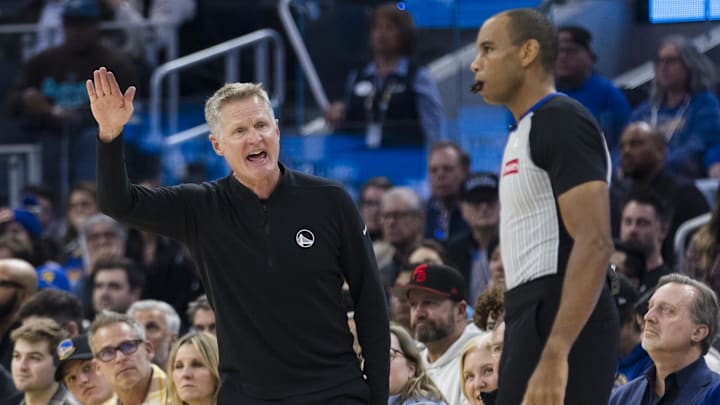 Dec 30, 2024; San Francisco, California, USA; Golden State Warriors head coach Steve Kerr reacts behind official Phenizee Ransom during the first quarter of the game against the Cleveland Cavaliers against the Cleveland Cavaliers at Chase Center. Mandatory Credit: John Hefti-Imagn Images