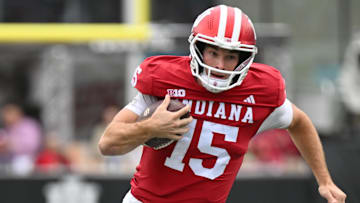Oct 25, 2025; Bloomington, Indiana, USA; Indiana Hoosiers quarterback Fernando Mendoza (15) runs the ball during the second half against the UCLA Bruins at Memorial Stadium. Mandatory Credit: Robert Goddin-Imagn Images