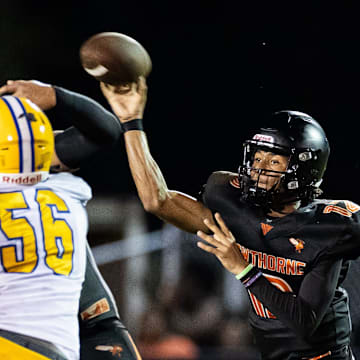 Hawthorne Hornets quarterback Adrian Curtis (12) throws under pressure against the Newberry Panthers during the first half at Hawthorne High School Football Stadium in Hawthorne, FL on Friday, August 30, 2024. [Matt Pendleton/Gainesville Sun]