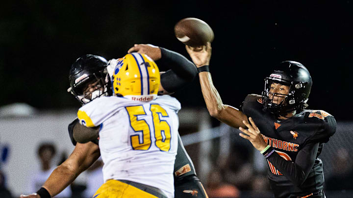 Hawthorne Hornets quarterback Adrian Curtis (12) throws under pressure against the Newberry Panthers during the first half at Hawthorne High School Football Stadium in Hawthorne, FL on Friday, August 30, 2024. [Matt Pendleton/Gainesville Sun]