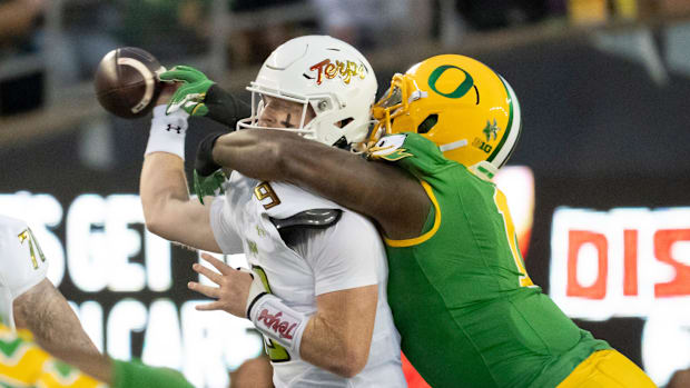 Oregon defensive end Jordan Burch forces a fumble from Maryland quarterback Billy Edwards Jr. as the Oregon Ducks host the Ma