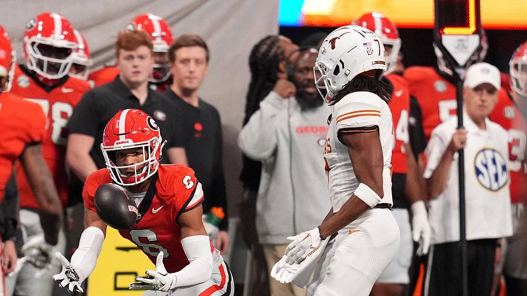 Georgia Bulldogs defensive back Daylen Everette (6) makes an interception against Texas Longhorns wide receiver Isaiah Bond (7) during the first half in the 2024 SEC Championship game at Mercedes-Benz Stadium.