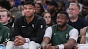 Dec 23, 2023; New York, New York, USA;  Milwaukee Bucks forward Giannis Antetokounmpo (l) and his brother Milwaukee Bucks forward Thanasis Antetokounmpo (r) watch the game from the bench in the fourth quarter against the New York Knicks at Madison Square Garden. Mandatory Credit: Wendell Cruz-Imagn Images