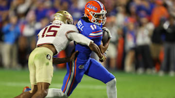 Florida wide receiver Aidan Mizell (11) makes yards against Florida defensive lineman Jayden Woods (15) during the second half of an NCAA football game at Steve Spurrier Field at Ben Hill Griffin Stadium in Gainesville, FL on Saturday, November 29, Florida beat Florida State 40-21.2025. [Alan Youngblood/Gainesville Sun]