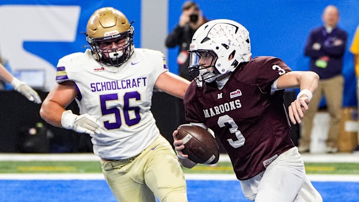 Menominee quarterback Tanner Theuerkauf (3) looks to pass against Schoolcraft defensive lineman Liam Haines (56) during the first half of MHSAA Division 7 final at Ford Field in Detroit on Sunday, Nov. 30, 2025.