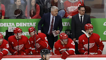 Dec 27, 2024; Detroit, Michigan, USA;  Detroit Red Wings head coach Todd McLellan  (center) stands on the bench in the third period against the Toronto Maple Leafs at Little Caesars Arena. Mandatory Credit: Rick Osentoski-Imagn Images