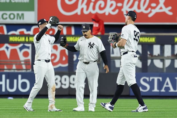 New York Yankees outfielders Cody Bellinger (35), Trent Grisham (12) and Aaron Judge (99)