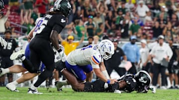 USF defensive back Ira Singleton (10) recovers a fumble from Boise State quarterback Maddux Madsen. It was one of three fumble recoveries for the Bulls.