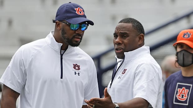 Auburn Tigers defensive coordinator Derek Mason (right) talks with cornerbacks coach Zac Etheridge 