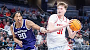 Mar 13, 2025; Indianapolis, IN, USA; Wisconsin Badgers forward Nolan Winter (31) dribbles the ball while Northwestern Wildcats guard Justin Mullins (20) defends in the second half at Gainbridge Fieldhouse. Mandatory Credit: Trevor Ruszkowski-Imagn Images