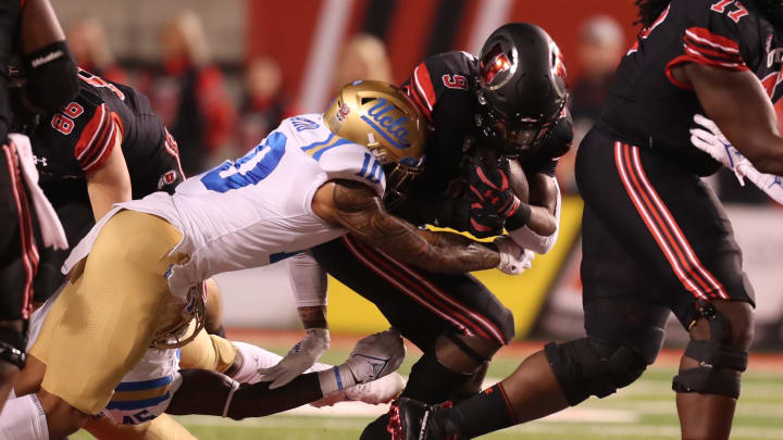 Oct 30, 2021; Salt Lake City, Utah, USA;  UCLA Bruins linebacker Ale Kaho (10) tackles Utah Utes running back Tavion Thomas (9) during the first quarter at Rice-Eccles Stadium. Mandatory Credit: Rob Gray-USA TODAY Sports