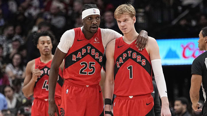 Jan 17, 2024; Toronto, Ontario, CAN; Toronto Raptors forward Chris Boucher (25) talks with guard Gradey Dick (1) during a break in the action against the Miami Heat during the second half at Scotiabank Arena. Mandatory Credit: John E. Sokolowski-USA TODAY Sports