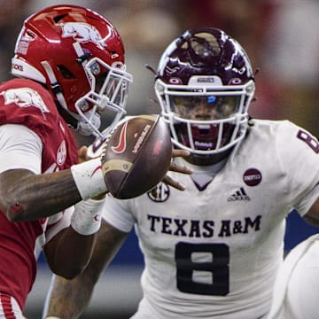 Arkansas Razorbacks quarterback KJ Jefferson (1) loses the football as he is being chased by Texas A&M Aggies defensive lineman DeMarvin Leal (8) during the second half at AT&T Stadium. 