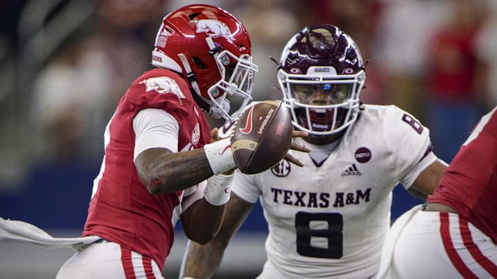 Arkansas Razorbacks quarterback KJ Jefferson (1) loses the football as he is being chased by Texas A&M Aggies defensive lineman DeMarvin Leal (8) during the second half at AT&T Stadium. 