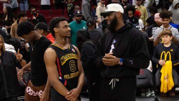 Mar 28, 2023; Houston, TX, USA; West guard Bronny James (6) with father LeBron James following the McDonald's All American Boy's high school basketball game at Toyota Center. Mandatory Credit: Mark J. Rebilas-USA TODAY Sports