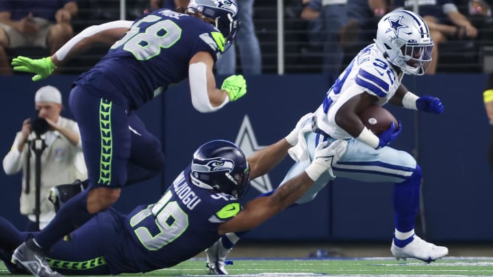 Aug 26, 2022; Arlington, Texas, USA;  Seattle Seahawks linebacker Joshua Onujiogu (49) tackles Dallas Cowboys running back Aaron Shampklin (32) during the first quarter at AT&T Stadium.