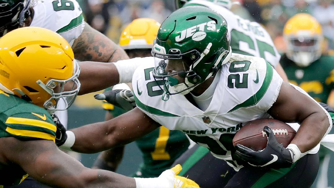Green Bay Packers defensive tackle Kenny Clark (97) tackles New York Jets running back Breece Hall  in 2022.