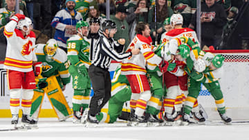 Jan 25, 2025; Saint Paul, Minnesota, USA; The Minnesota Wild and Calgary Flames fight resulting in three penalties for each side in the second period at Xcel Energy Center. Mandatory Credit: Matt Blewett-Imagn Images