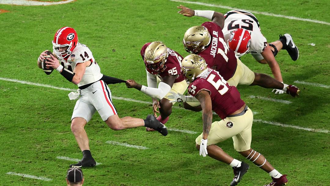 Dec 30, 2023; Miami Gardens, FL, USA; Florida State Seminoles defensive lineman Daniel Lyons (95) tackles Georgia Bulldogs quarterback Gunner Stockton (14) during the second half in the 2023 Orange Bowl at Hard Rock Stadium. Mandatory Credit: Sam Navarro-Imagn Images