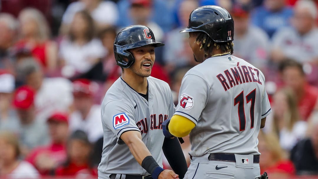 Aug 15, 2023; Cincinnati, Ohio, USA; Cleveland Guardians left fielder Steven Kwan (38) celebrates with third baseman Jose Ramirez (11) after scoring on a two-run single hit by first baseman Kole Calhoun (not pictured) in the first inning against the Cincinnati Reds at Great American Ball Park. Mandatory Credit: Katie Stratman-Imagn Images