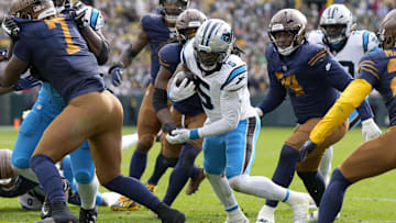 Nov 2, 2025; Green Bay, Wisconsin, USA; Carolina Panthers running back Rico Dowdle (5) scores a touchdown during the first half against the Green Bay Packers at Lambeau Field. 