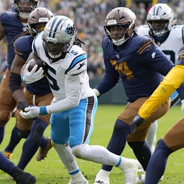 Nov 2, 2025; Green Bay, Wisconsin, USA; Carolina Panthers running back Rico Dowdle (5) scores a touchdown during the first half against the Green Bay Packers at Lambeau Field. 