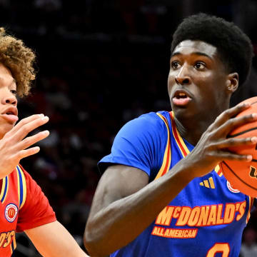 Apr 2, 2024; Houston, TX, USA; McDonald's All American East guard Drake Powell (9) drives to the basket around McDonald's All American West guard Trent Perry (0) during the first half at Toyota Center. Mandatory Credit: Maria Lysaker-USA TODAY Sports