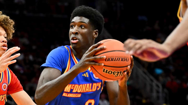 Apr 2, 2024; Houston, TX, USA; McDonald's All American East guard Drake Powell (9) drives to the basket around McDonald's All American West guard Trent Perry (0) during the first half at Toyota Center. Mandatory Credit: Maria Lysaker-USA TODAY Sports