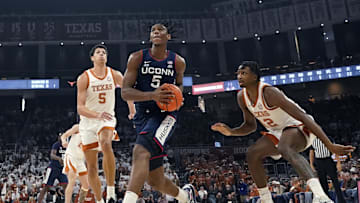 UConn Huskies center Tarris Reed Jr. drives to the basket between Texas Longhorns guard Tramon Mark and forward Kadin Shedrick (5) during the first half at Moody Center.