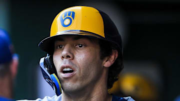Milwaukee Brewers designated hitter Christian Yelich (22) high fives teammates after hitting a solo home run in the second inning against the Cincinnati Reds at Great American Ball Park on Aug. 15. 