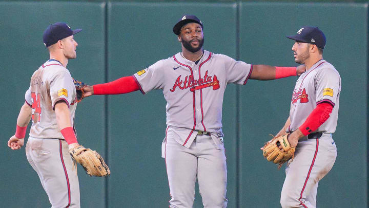 Atlanta Braves outfielders Jarred Kelenic, Michael Harris II, and Ramón Laureano celebrate the sweep of the Minnesota Twins.