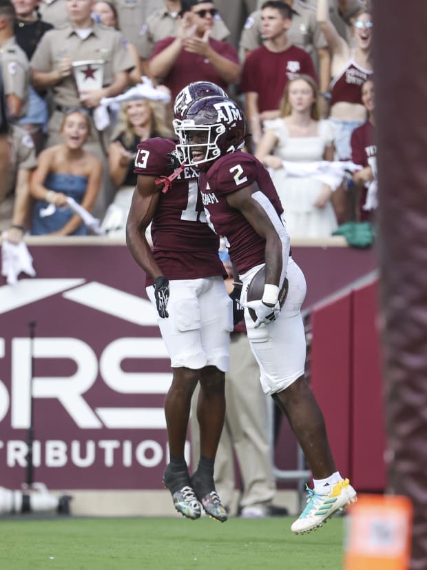 Texas A&M Aggies running back Rueben Owens (2) celebrates with wide receiver Micah Tease (13) after scoring a touchdown. 