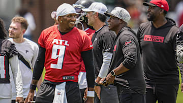 Jun 11, 2025; Atlanta, GA, USA; Atlanta Falcons quarterback Michael Penix Jr. (9) and head coach Raheem Morris on the field during Minicamp at Children's Healthcare of Atlanta Training Ground. Mandatory Credit: Dale Zanine-Imagn Images