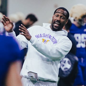 Kevin Cummings demonstrates a receiving technique during spring ball. 