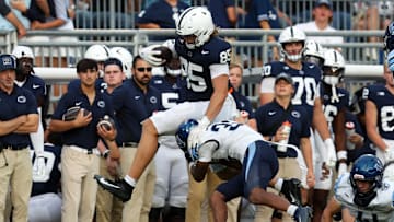 Penn State football tight end Luke Reynolds (85) leaps over  Villanova Wildcats defensive back Damill Bostic Jr.