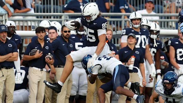 Penn State Nittany Lions tight end Luke Reynolds leaps over  Villanova Wildcats defensive back Damill Bostic Jr.