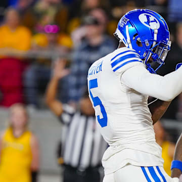 Sep 14, 2024; Laramie, Wyoming, USA; Brigham Young Cougars wide receiver Darius Lassiter (5) celebrates after scoring a touchdown against the Wyoming Cowboys during the third quarter at Jonah Field at War Memorial Stadium. 