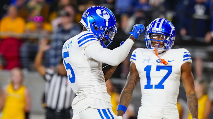 Sep 14, 2024; Laramie, Wyoming, USA; Brigham Young Cougars wide receiver Darius Lassiter (5) celebrates after scoring a touchdown against the Wyoming Cowboys during the third quarter at Jonah Field at War Memorial Stadium. 