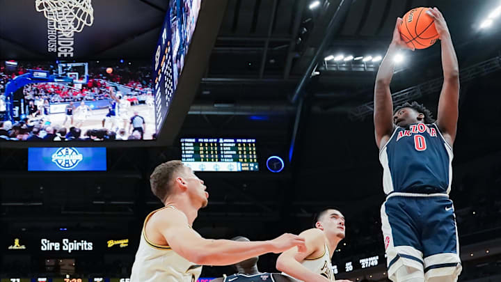 Dec 16, 2023; Indianapolis, Indiana, USA;  Arizona Wildcats guard Jaden Bradley (0) rebounds the ball against the Purdue Boilermakers during the second half at Gainbridge Fieldhouse. Mandatory Credit: Robert Goddin-Imagn Images
