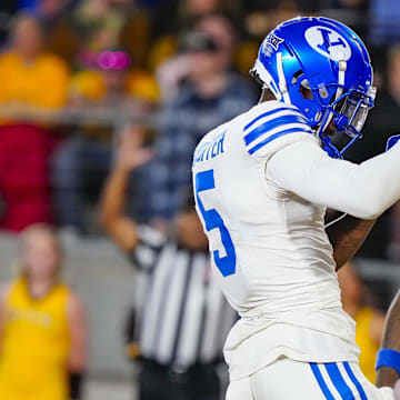 Sep 14, 2024; Laramie, Wyoming, USA; Brigham Young Cougars wide receiver Darius Lassiter (5) celebrates after scoring a touchdown against the Wyoming Cowboys during the third quarter at Jonah Field at War Memorial Stadium.