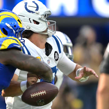 Sep 28, 2025; Inglewood, California, USA; Los Angeles Rams linebacker Jared Verse (8) forces a fumble by Indianapolis Colts quarterback Daniel Jones (17) in the fourth quarter at SoFi Stadium. Mandatory Credit: Jayne Kamin-Oncea-Imagn Images
