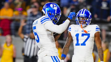 Darius Lassiter and Keelan Marion celebrate as the Cougars take down Wyoming 34-14.