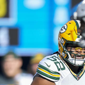 Green Bay Packers linebacker Rashan Gary (52) eyes Carolina Panthers quarterback Bryce Young during their game in 2023.