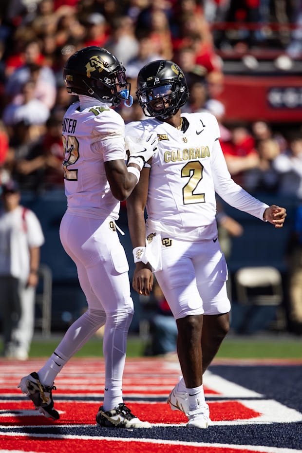 Oct 19, 2024; Tucson, Arizona, USA; Colorado Buffalos quarterback Shedeur Sanders (2) with wide receiver Travis Hunter (12) a