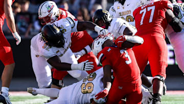 Oct 19, 2024; Tucson, Arizona, USA; Colorado Buffaloes defensive tackle Anquin Barnes Jr. (92) pulls the face mask of Arizona Wildcats running back Kedrick Reescano (3) during the fourth quarter at Arizona Stadium. Mandatory Credit: Aryanna Frank-Imagn Images