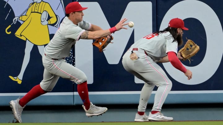 Aug 7, 2024; Los Angeles, California, USA;  Philadelphia Phillies right fielder Nick Castellanos (9) plays a double off the wall as left fielder Brandon Marsh (16) ducks out of the way hit by Los Angeles Dodgers left fielder Teoscar Hernandez (37) in the second inning at Dodger Stadium.